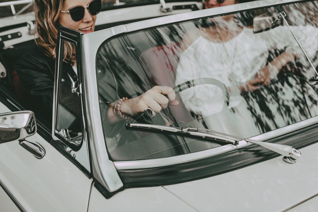 Woman driving convertible car, aesthetic road trip photo