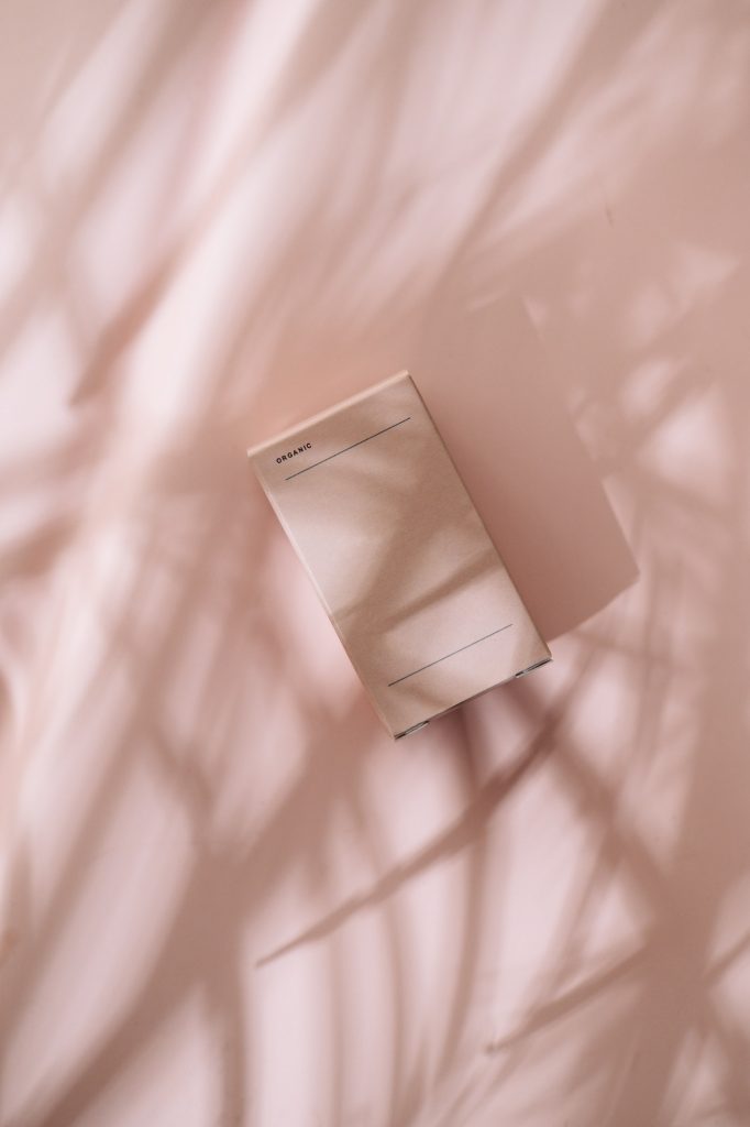 Minimalist beauty box on pastel pink in leaves shadows